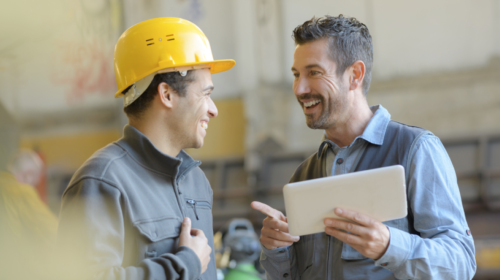 workers talk and laugh at a factory