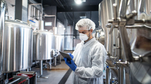 World-class OEE - Men holding tablet in factory