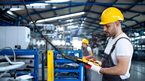 Safety - worker holding tablet in factory