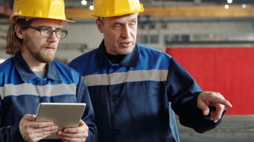 Two people having a discussion in a factory